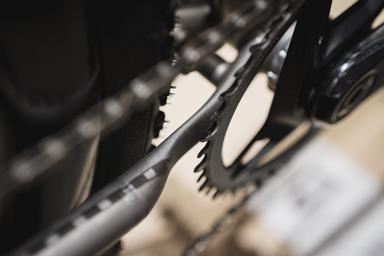 後輪付近の自転車のチェーンリング、チェーン、フレームのクローズアップ。.