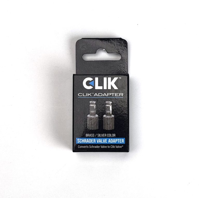 CLIK VALVE CORE FOR SCHRADER（シュレーダー用CLIKバルブコア）（2個入り）と書かれたダストキャップ付きの黒い箱で、シュレーダーバルブをク リックバルブに変換するための真鍮/銀のアダプターが入っている。.