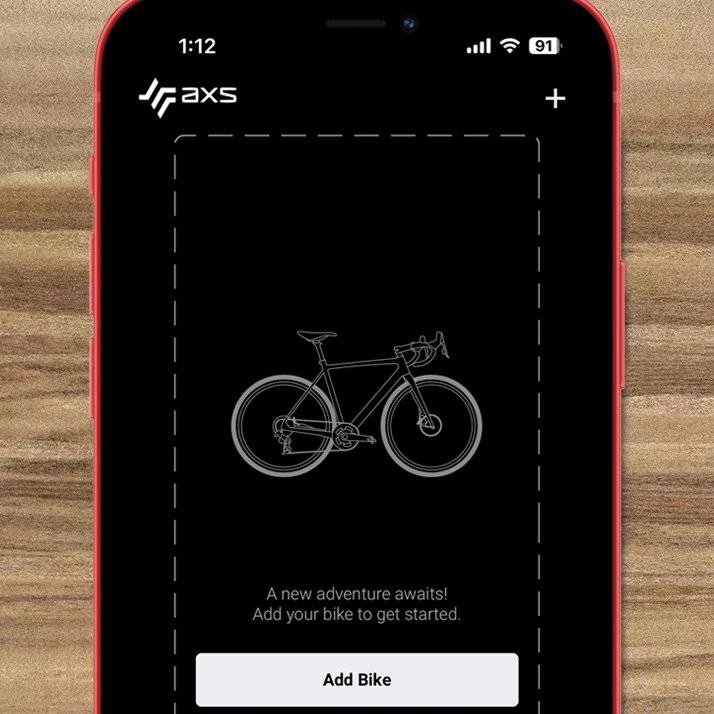 SRAM AXSのモバイルアプリの画面で、自転車のシルエットと自転車を追加ボタンが表示され、ユーザーに自転車の追加を促している。.