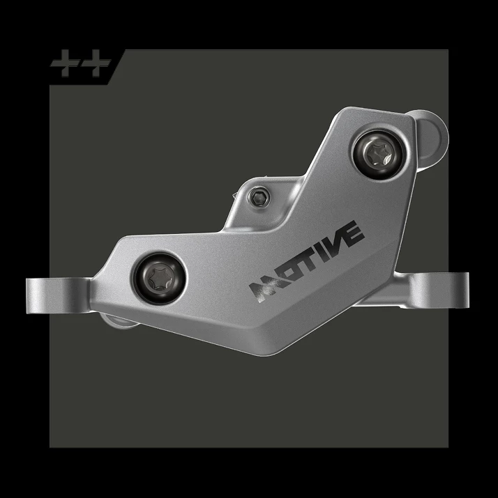 Motiveのロゴが入ったグレーの自転車用ディスクブレーキキャリパー。.